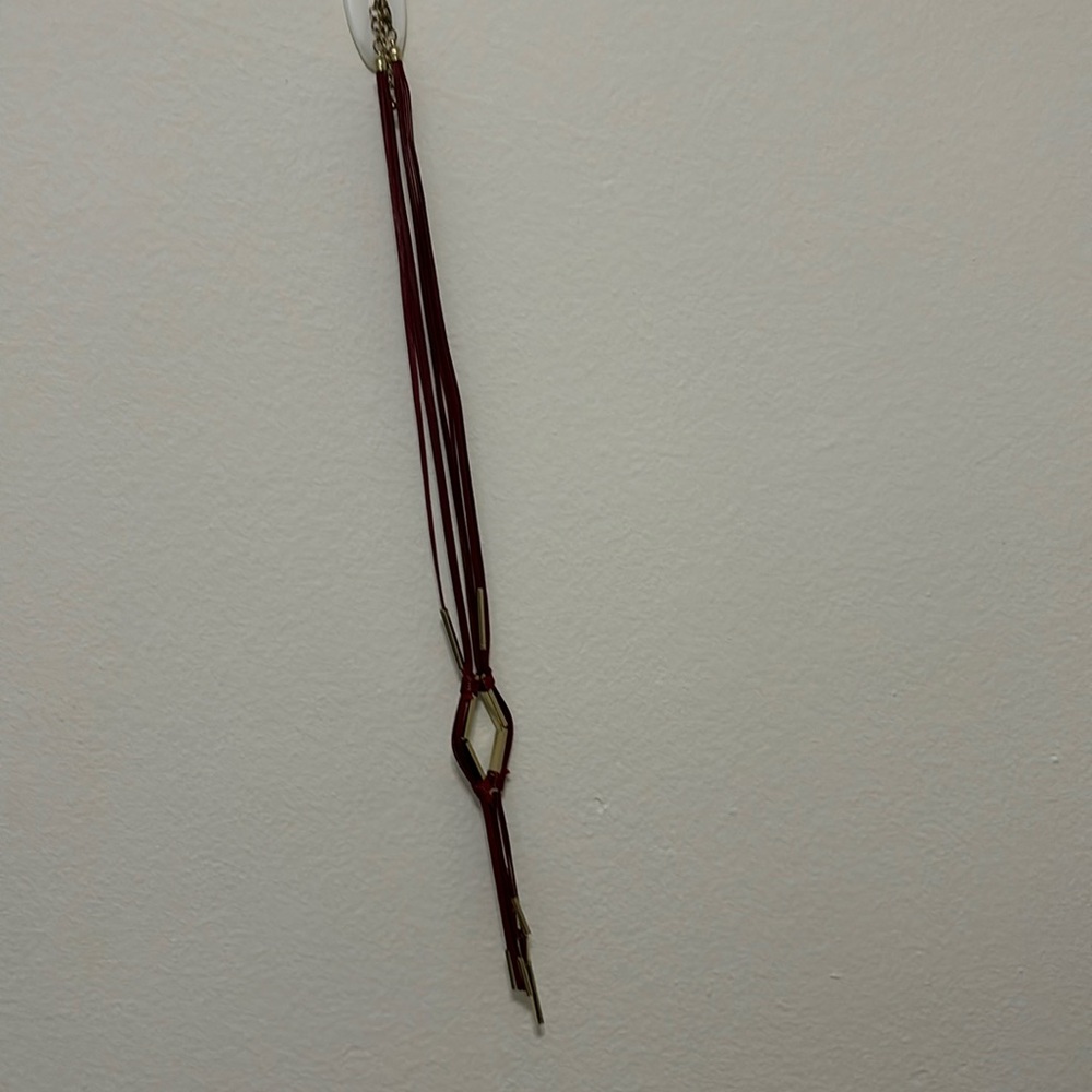 Long maroon pleather necklace with gold accents